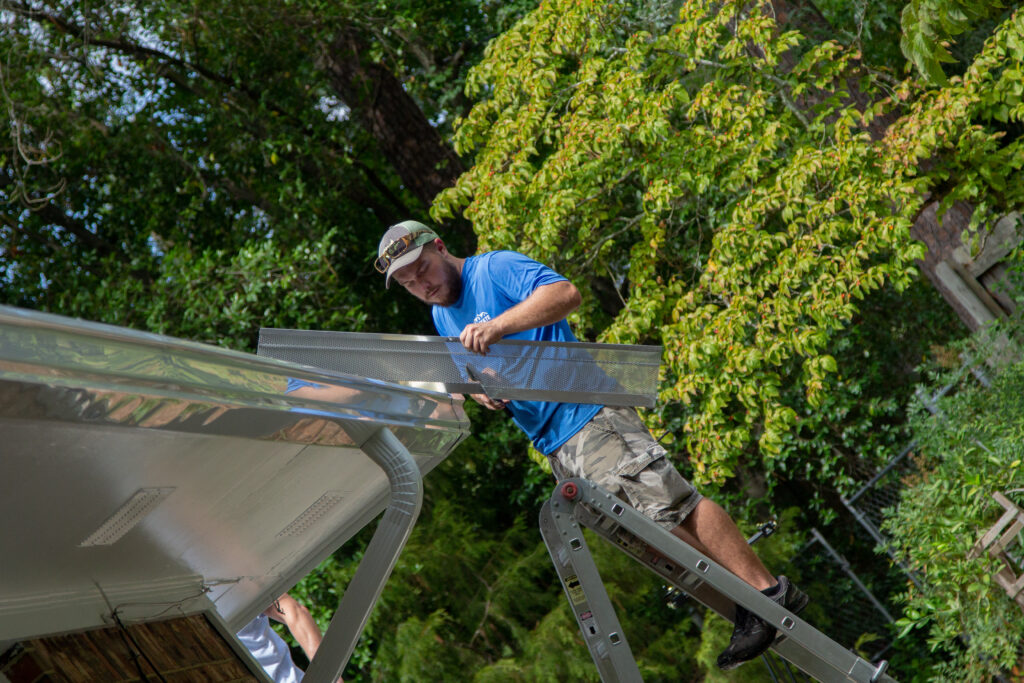 Gutter pro installs another piece of lifetime gutter protection on seamless gutter install by Columbia Gutter Pros